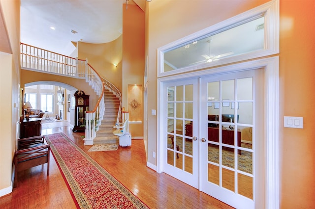 4815 N Pine Brook Way, Houston, TX 77059 - foyer entrance with ceiling fan, wood finished floors, french doors, arched walkways, and stairway