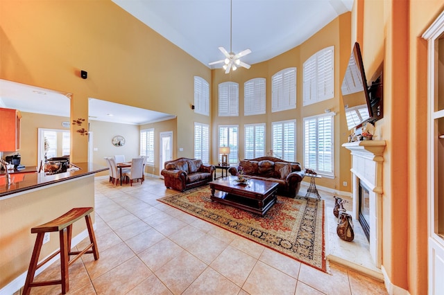 4815 N Pine Brook Way, Houston, TX 77059 - living area featuring light tile patterned floors, a high ceiling, a premium fireplace, and a ceiling fan