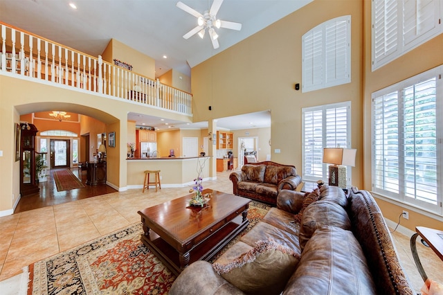 4815 N Pine Brook Way, Houston, TX 77059 - tiled living room with a ceiling fan, arched walkways, and high vaulted ceiling