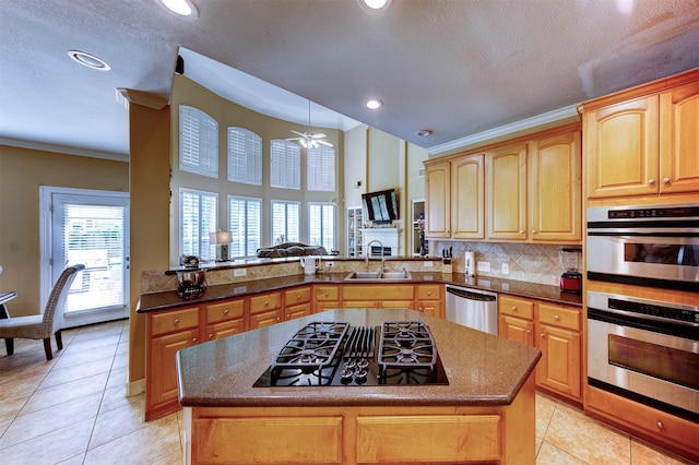4815 N Pine Brook Way, Houston, TX 77059 - kitchen with stainless steel appliances, light tile patterned floors, a kitchen island, decorative backsplash, and a ceiling fan