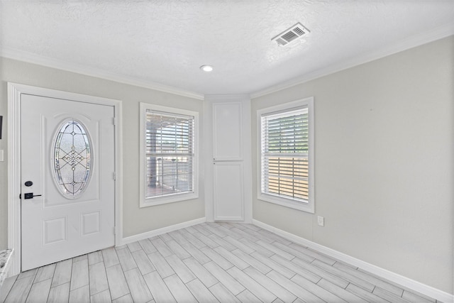 7941 Goode St, Houston, TX 77012 - entryway featuring ornamental molding, healthy amount of natural light, baseboards, and a textured ceiling