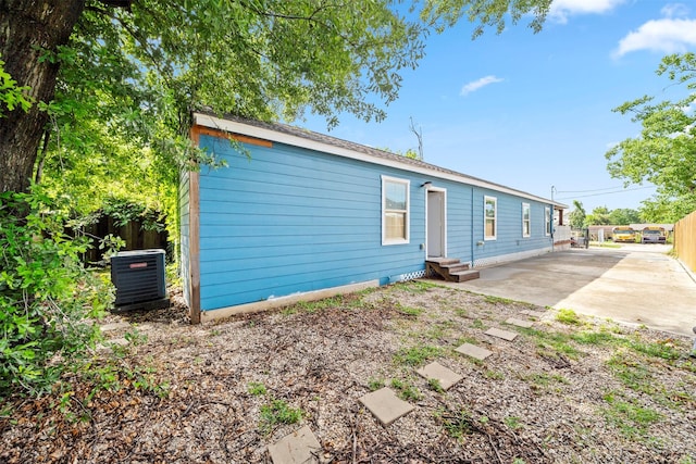 7941 Goode St, Houston, TX 77012 - back of property featuring cooling unit, entry steps, a patio area, and concrete driveway