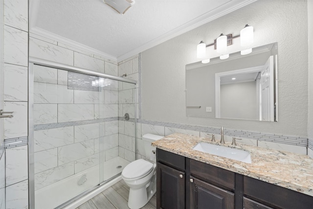 7941 Goode St, Houston, TX 77012 - bathroom with ornamental molding, a stall shower, vanity, toilet, and tile walls