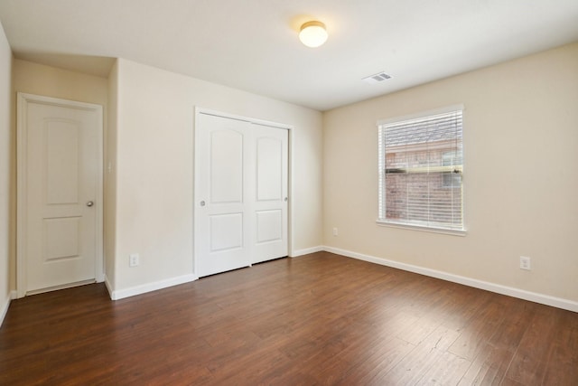 2813 Bottiglia Way, League City, TX 77573 - unfurnished bedroom with dark wood-type flooring, baseboards, and a closet