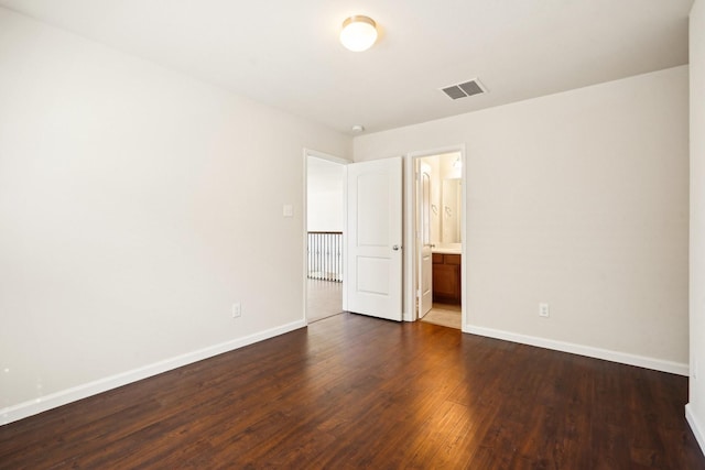 2813 Bottiglia Way, League City, TX 77573 - unfurnished bedroom with baseboards, dark wood-style floors, and connected bathroom