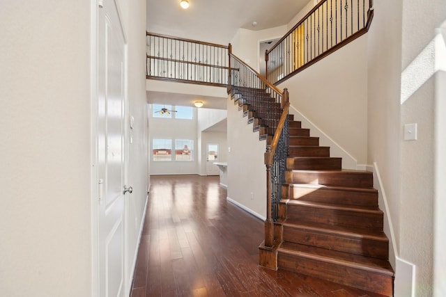 2813 Bottiglia Way, League City, TX 77573 - stairway featuring hardwood / wood-style floors, baseboards, and a towering ceiling