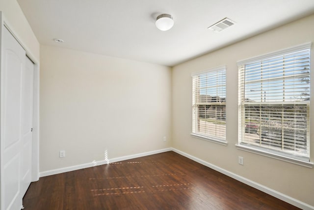 2813 Bottiglia Way, League City, TX 77573 - unfurnished bedroom featuring dark wood-style floors, baseboards, and a closet