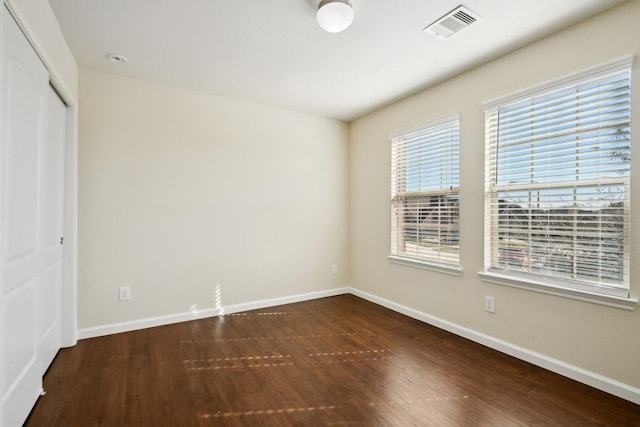 2813 Bottiglia Way, League City, TX 77573 - unfurnished bedroom featuring dark wood-type flooring, baseboards, and a closet