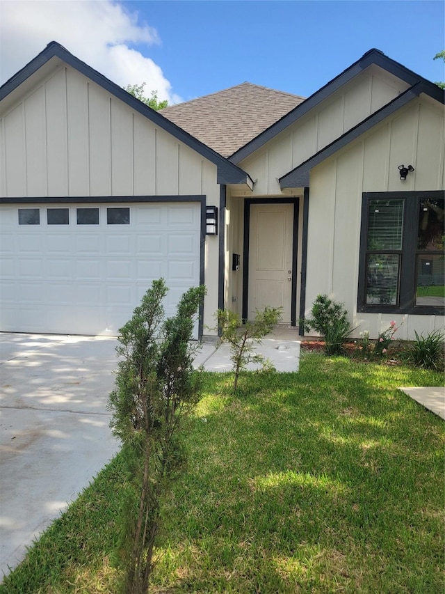 4354 Phlox St, Houston, TX 77051 - ranch-style home featuring board and batten siding, a front yard, a shingled roof, and a garage