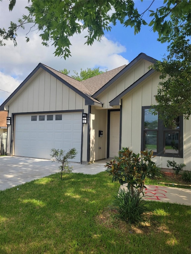4354 Phlox St, Houston, TX 77051 - single story home featuring board and batten siding, roof with shingles, a front lawn, driveway, and an attached garage