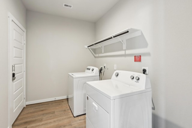 29211 Pikes Peak Dr, Katy, TX 77494 - laundry area featuring washing machine and dryer, light wood-style flooring, and baseboards