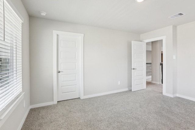 29211 Pikes Peak Dr, Katy, TX 77494 - unfurnished bedroom featuring carpet floors, multiple windows, and baseboards
