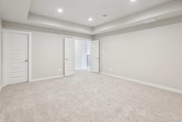 29211 Pikes Peak Dr, Katy, TX 77494 - unfurnished bedroom featuring light carpet, baseboards, recessed lighting, and a tray ceiling