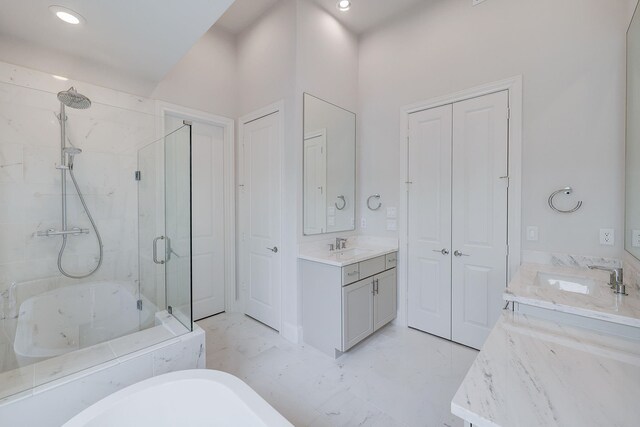 8710 Park Kolbe Ln, Houston, TX 77080 - bathroom with a freestanding bath, two vanities, a marble finish shower, marble look tiles, and recessed lighting