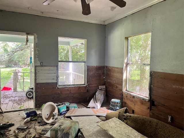 720 Birch, Vidor, TX 77662 - empty room featuring plenty of natural light, wooden walls, a wainscoted wall, and ceiling fan