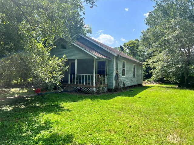 720 Birch, Vidor, TX 77662 - view of home's exterior featuring a lawn and a sunroom