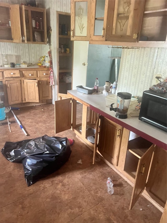 720 Birch, Vidor, TX 77662 - kitchen with wallpapered walls, black microwave, light countertops, glass insert cabinets, and open shelves