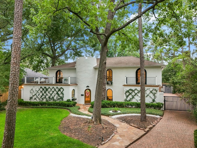 11 Twin Circle Dr, Houston, TX 77042 - view of front of home with a balcony, a gate, and stucco siding