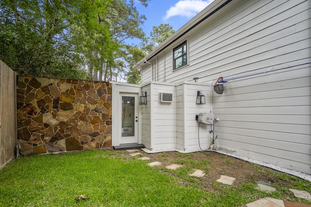 11 Twin Circle Dr, Houston, TX 77042 - doorway to property with a lawn and a wall mounted air conditioner