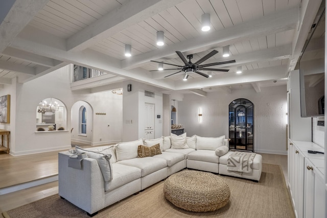 11 Twin Circle Dr, Houston, TX 77042 - living room featuring arched walkways, ceiling fan, wooden ceiling with exposed beams, light wood-style floors, and a chandelier