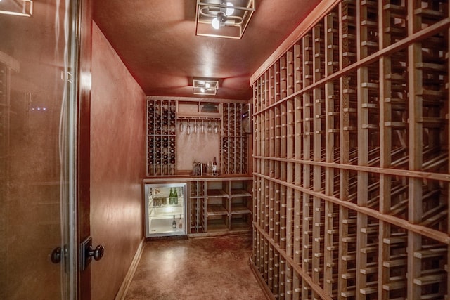 11 Twin Circle Dr, Houston, TX 77042 - wine room with beverage cooler, concrete flooring, and baseboards