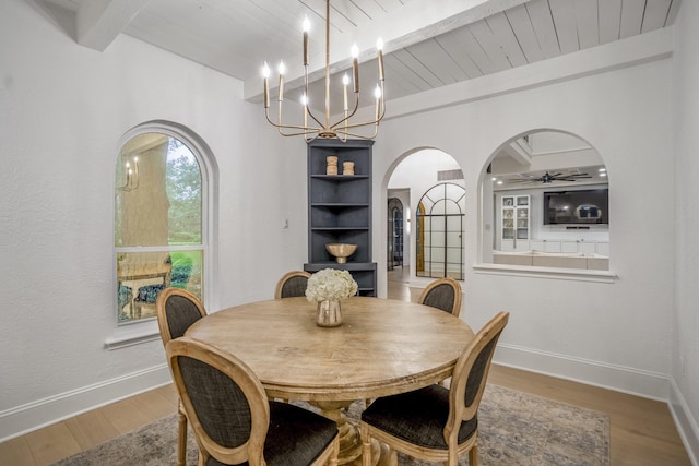11 Twin Circle Dr, Houston, TX 77042 - dining space with arched walkways, wood finished floors, baseboards, a ceiling fan, and wooden ceiling with exposed beams