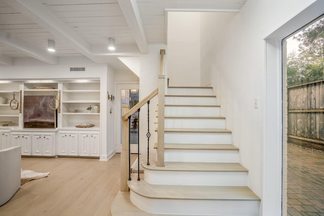 11 Twin Circle Dr, Houston, TX 77042 - staircase featuring beamed ceiling and wood finished floors