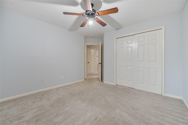19315 Oak Station Dr, Humble, TX 77346 - unfurnished bedroom with carpet flooring, baseboards, a closet, and ceiling fan