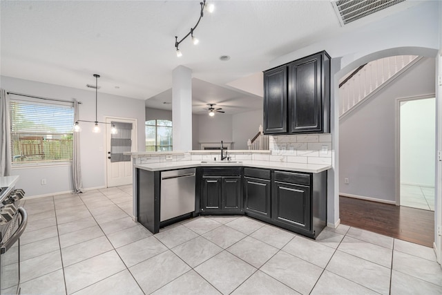 19315 Oak Station Dr, Humble, TX 77346 - kitchen with dishwasher, light countertops, a sink, range with gas cooktop, and ceiling fan