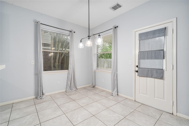 19315 Oak Station Dr, Humble, TX 77346 - unfurnished dining area with light tile patterned flooring and baseboards
