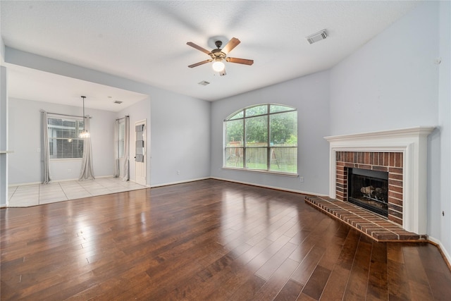 19315 Oak Station Dr, Humble, TX 77346 - unfurnished living room featuring ceiling fan, wood finished floors, a fireplace, and baseboards