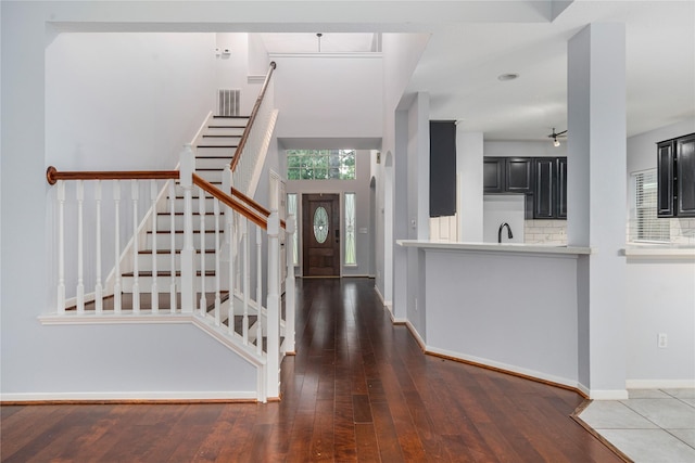 19315 Oak Station Dr, Humble, TX 77346 - foyer entrance featuring wood-type flooring, stairs, and baseboards