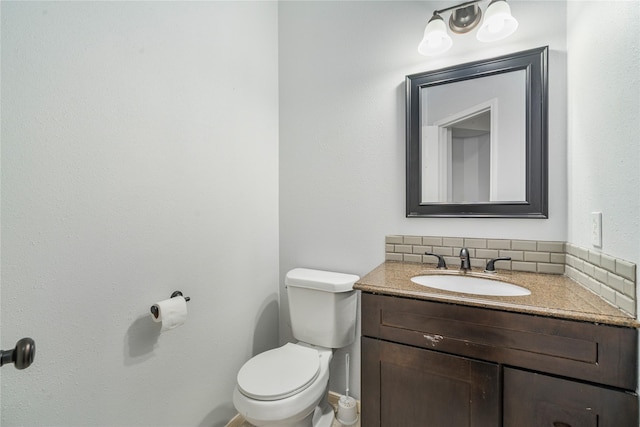 19315 Oak Station Dr, Humble, TX 77346 - half bath featuring vanity, toilet, backsplash, and baseboards