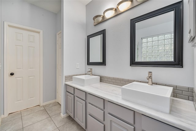 19315 Oak Station Dr, Humble, TX 77346 - bathroom with double vanity, tile patterned floors, and baseboards