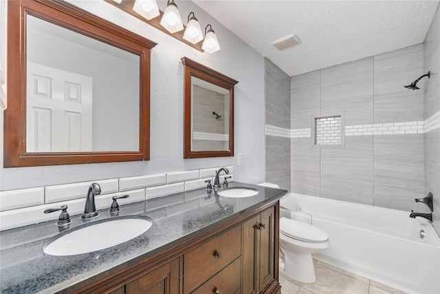 19315 Oak Station Dr, Humble, TX 77346 - full bathroom featuring toilet, double vanity, shower / bathtub combination, tile patterned floors, and a textured ceiling