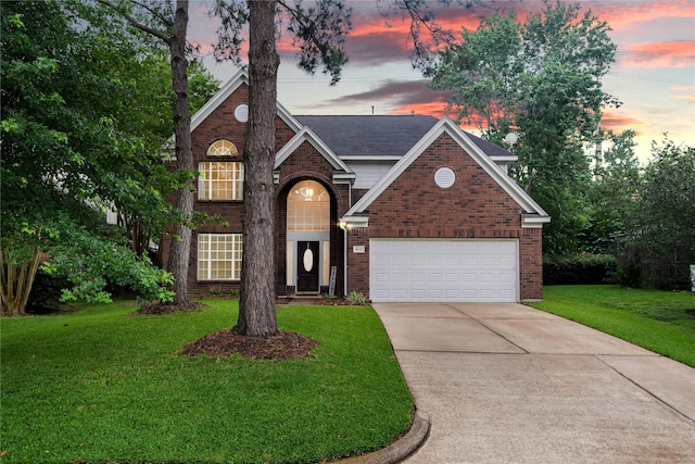 19315 Oak Station Dr, Humble, TX 77346 - traditional-style house with brick siding, concrete driveway, a front yard, and a garage