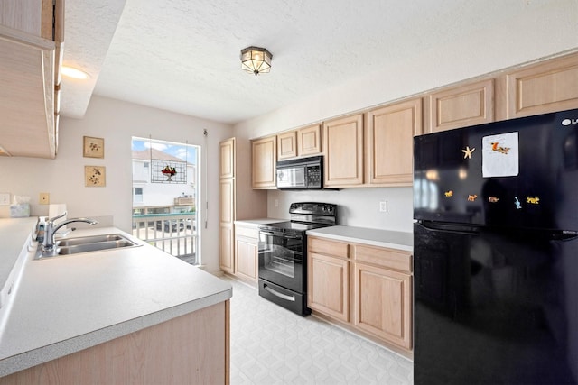 4122 Pirates Aly, Galveston, TX 77554 - kitchen featuring black appliances, light brown cabinets, a sink, a textured ceiling, and light countertops