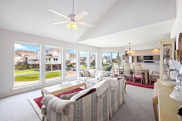 4122 Pirates Aly, Galveston, TX 77554 - carpeted living room with vaulted ceiling, a ceiling fan, and a chandelier