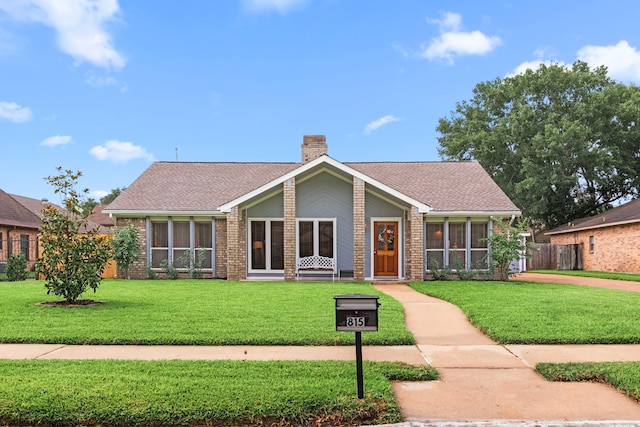 815 Millpond Dr, Sugar Land, TX 77498 - mid-century modern home featuring a chimney, brick siding, and roof with shingles