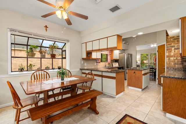 815 Millpond Dr, Sugar Land, TX 77498 - dining space with a ceiling fan, plenty of natural light, and light tile patterned flooring