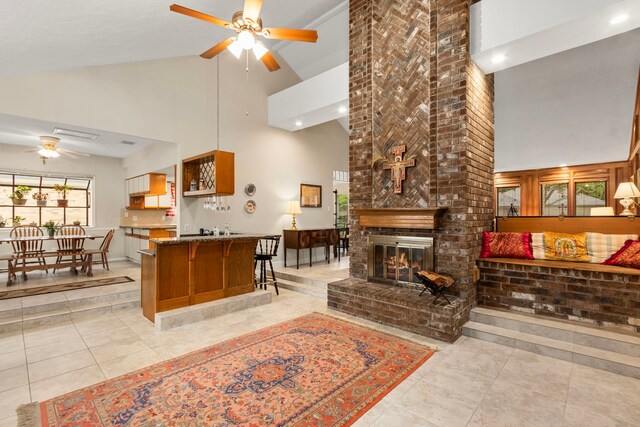 815 Millpond Dr, Sugar Land, TX 77498 - living room featuring high vaulted ceiling, a ceiling fan, light tile patterned flooring, a brick fireplace, and recessed lighting