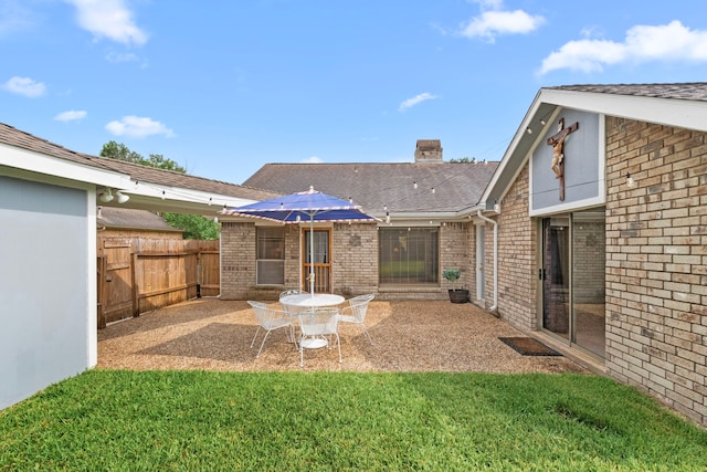 815 Millpond Dr, Sugar Land, TX 77498 - back of property with brick siding, a patio, a chimney, and roof with shingles