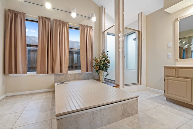 815 Millpond Dr, Sugar Land, TX 77498 - bathroom featuring tile patterned floors, vanity, and a stall shower