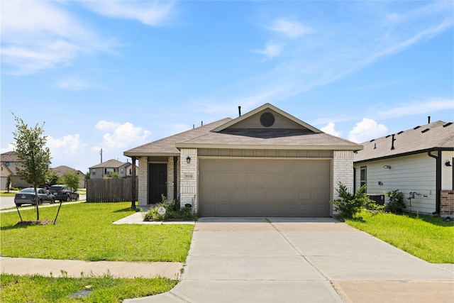 10530 Vinca Minor Ln, Houston, TX 77016 - ranch-style home with brick siding, a front lawn, concrete driveway, and an attached garage