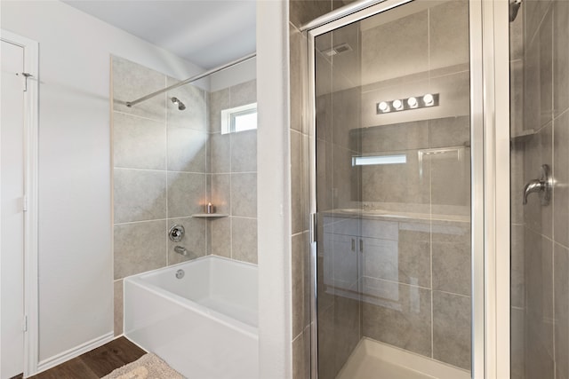 10530 Vinca Minor Ln, Houston, TX 77016 - bathroom featuring wood finished floors and combined bath / shower with glass door