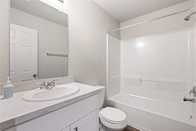 10530 Vinca Minor Ln, Houston, TX 77016 - bathroom featuring toilet, vanity, tub / shower combination, and a textured wall