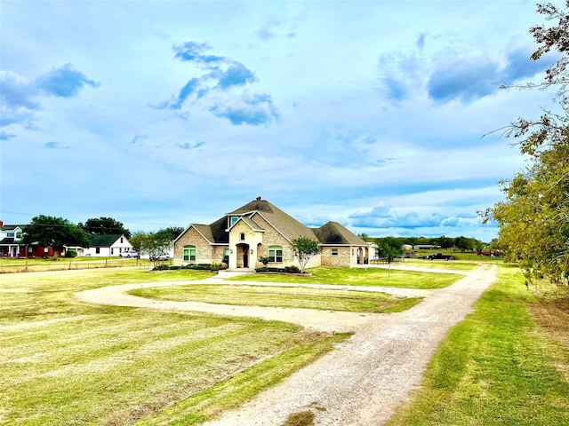 3898 County Road 135th Rd, Wharton, TX 77488 - french country home with dirt driveway, a front lawn, and stone siding