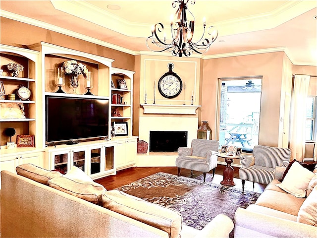 3898 County Road 135th Rd, Wharton, TX 77488 - living room with wood finished floors, a chandelier, a raised ceiling, a large fireplace, and ornamental molding