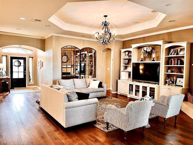 3898 County Road 135th Rd, Wharton, TX 77488 - living room with arched walkways, wood-type flooring, a tray ceiling, a chandelier, and crown molding