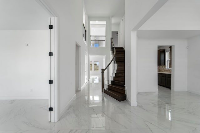 9818 Daffodil Springs Dr, Richmond, TX 77407 - foyer entrance featuring light marble finish flooring, stairway, and baseboards